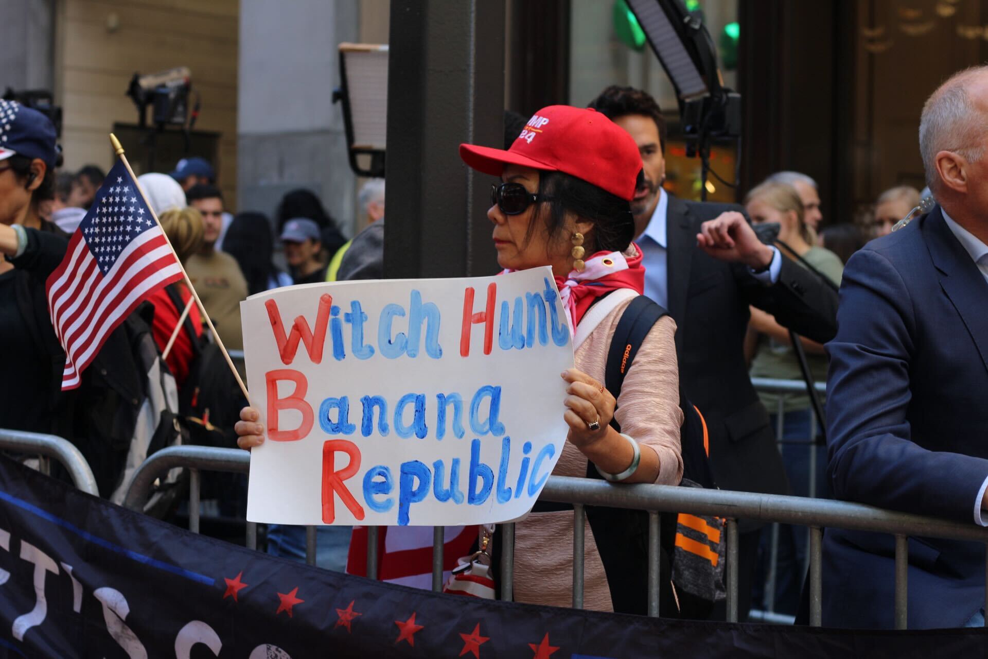 A Trump supporter holds a sign saying “Witch Hunt Banana Republic” outside of Trump Tower on 31 May