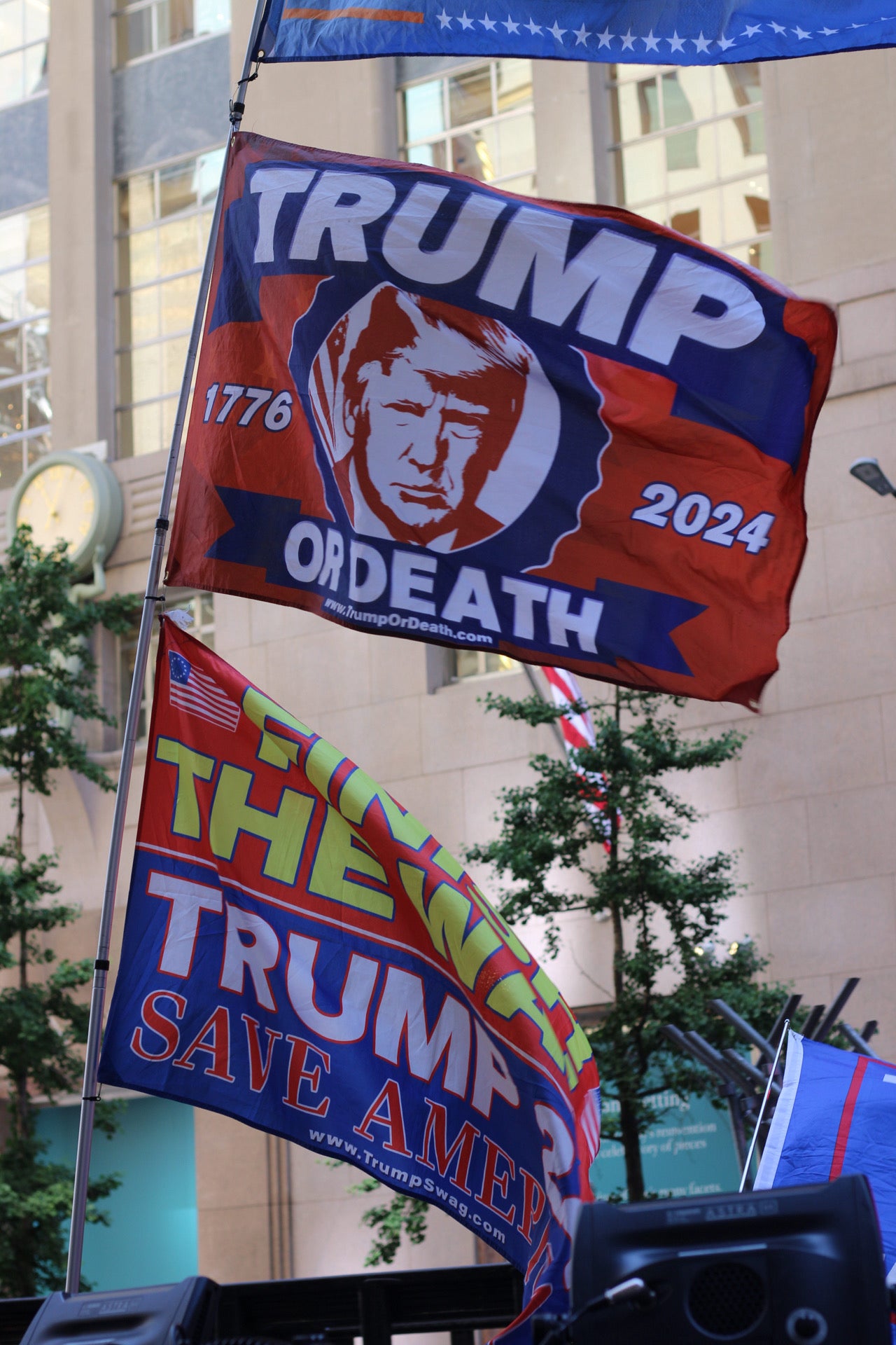 Trump supporters fly flags in front of Trump Tower as he prepares to speak about his guilty conviction on 31 May