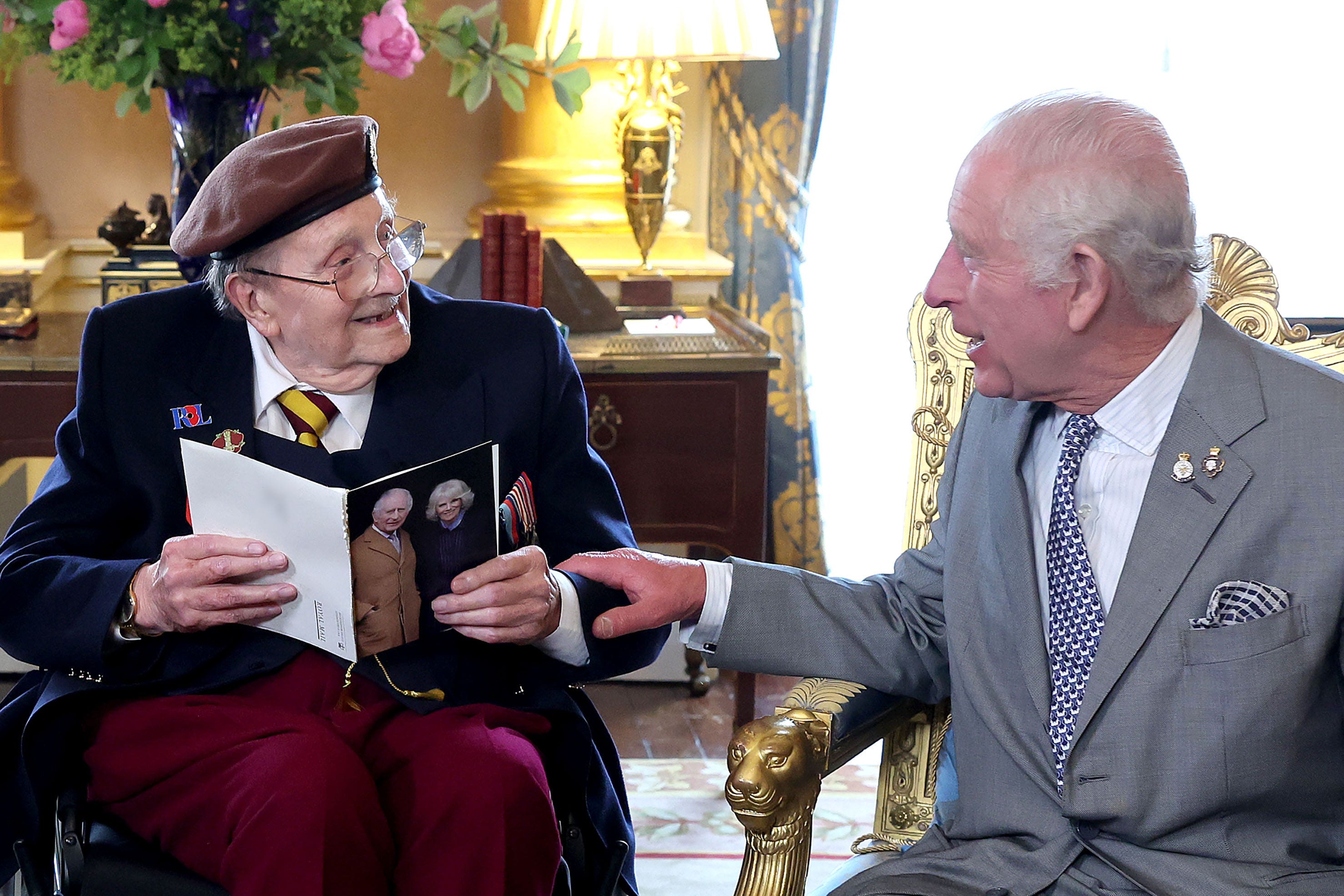 King Charles presented D-Day veteran Jim Miller with a card to mark his 100th birthday at Buckingham Palace (Chris Jackson/PA)