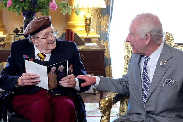 King Charles presented D-Day veteran Jim Miller with a card to mark his 100th birthday at Buckingham Palace (Chris Jackson/PA)