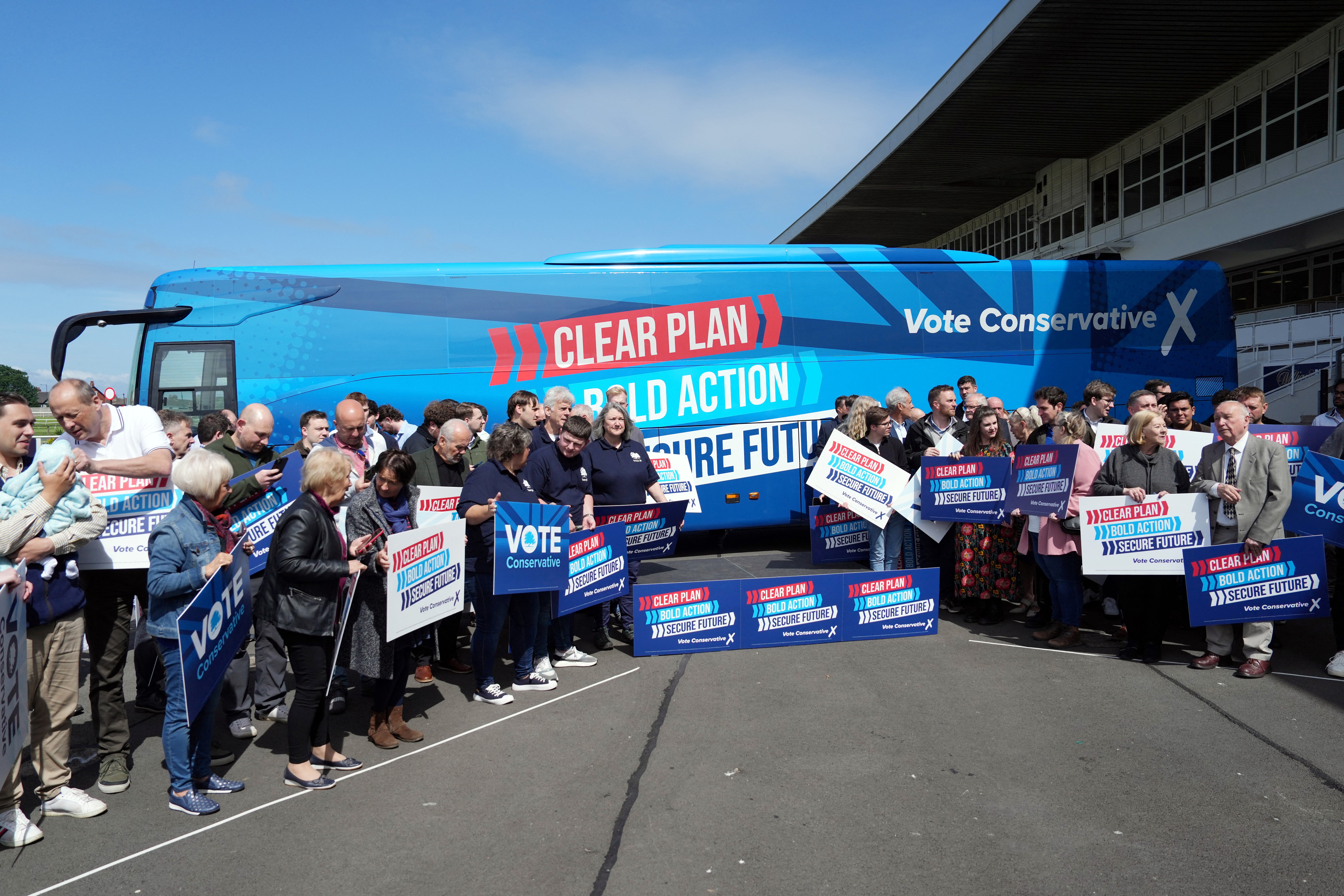 Supporters wait for British Prime Minister Rishi Sunak before launching the Conservative campaign bus