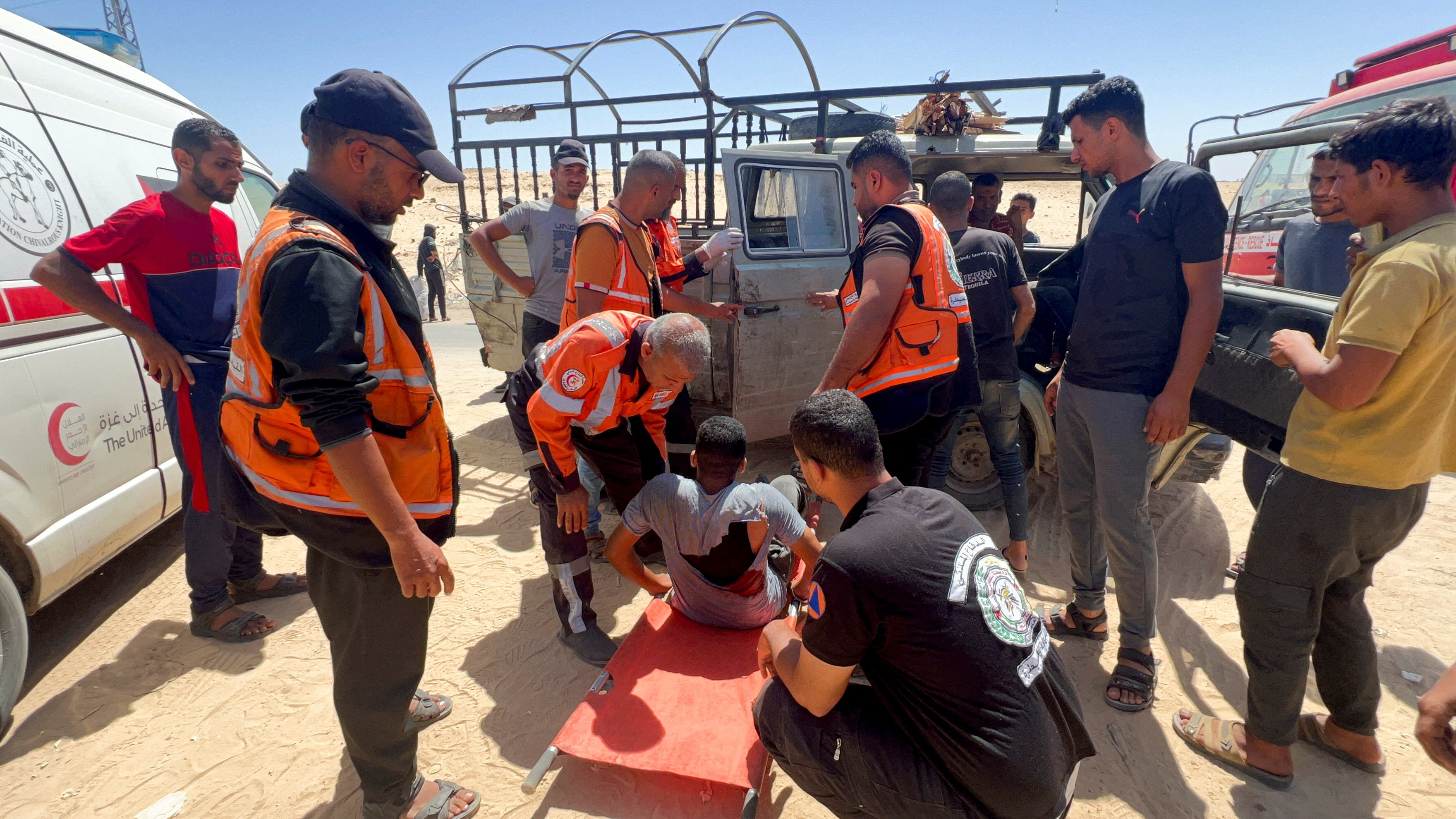 Paramedics carry a Palestinian man wounded by Israeli gunfire in Rafah yesterday