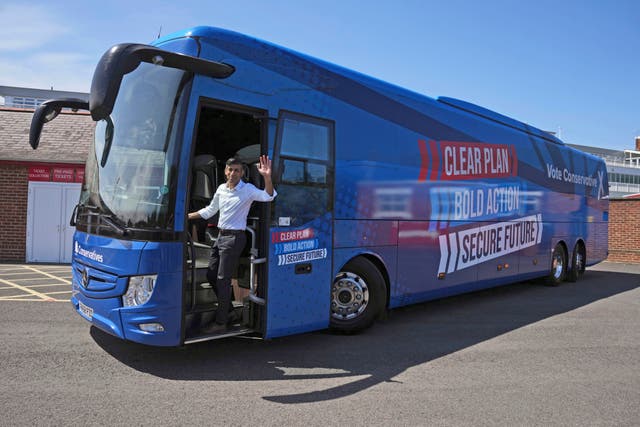 <p>Britain’s Prime Minister Rishi Sunak waves as he boards the Conservative campaign bus</p>
