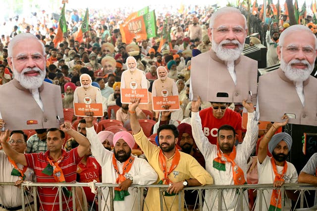 <p>Supporters of the ruling Bharatiya Janta Party hold cut-outs of India’s prime minister Narendra Modi during an election campaign rally in Amritsar </p>