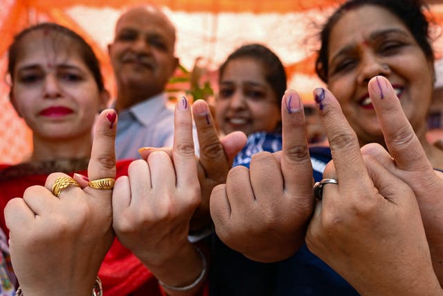 <p>Voters show their index fingers marked with indelible ink after casting their ballots to vote at a polling station in Amritsar on 1 June 2024</p>