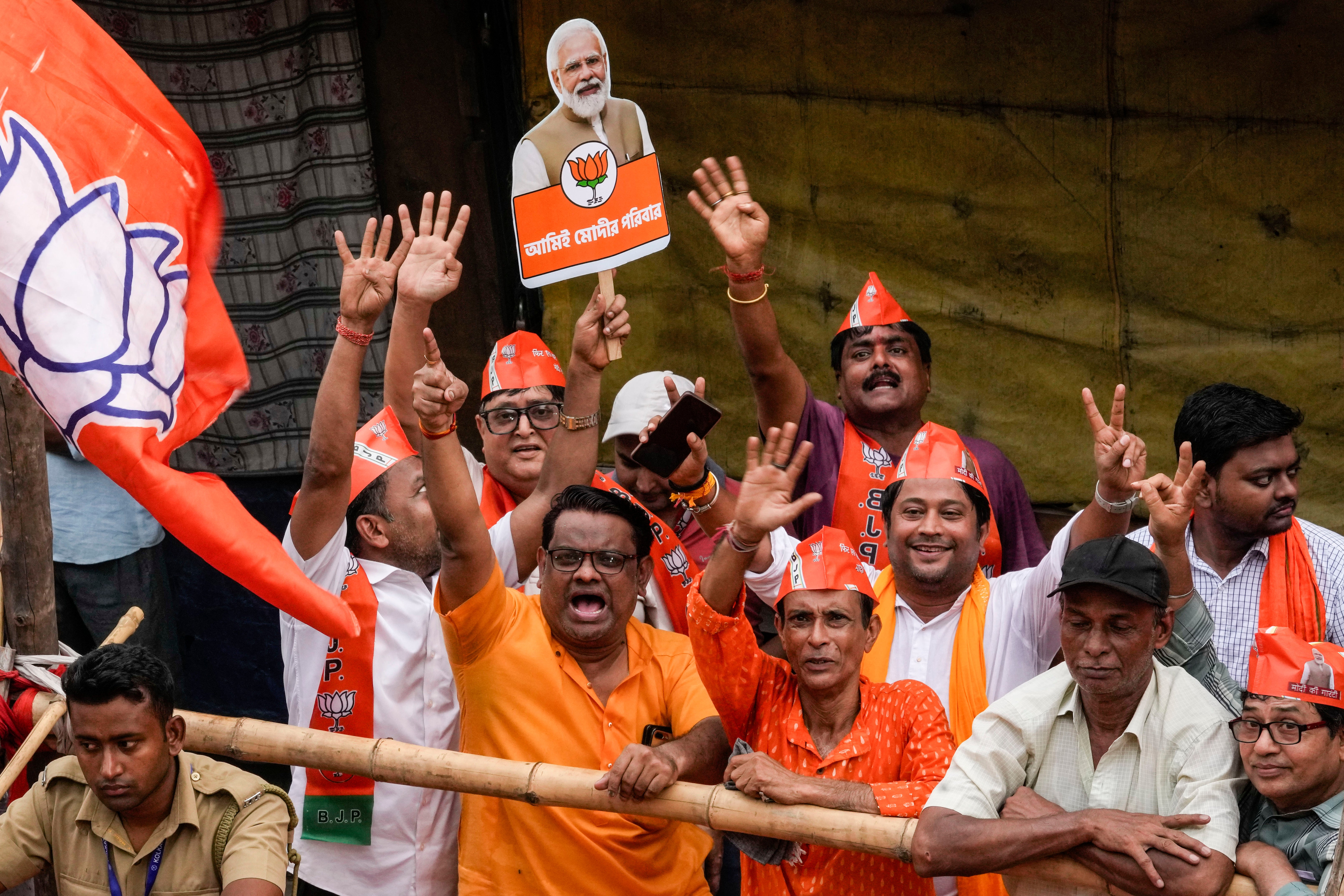 Supporters cheer to welcome Modi during a roadshow ahead of the last phase of elections in Kolkata, India on Tuesday