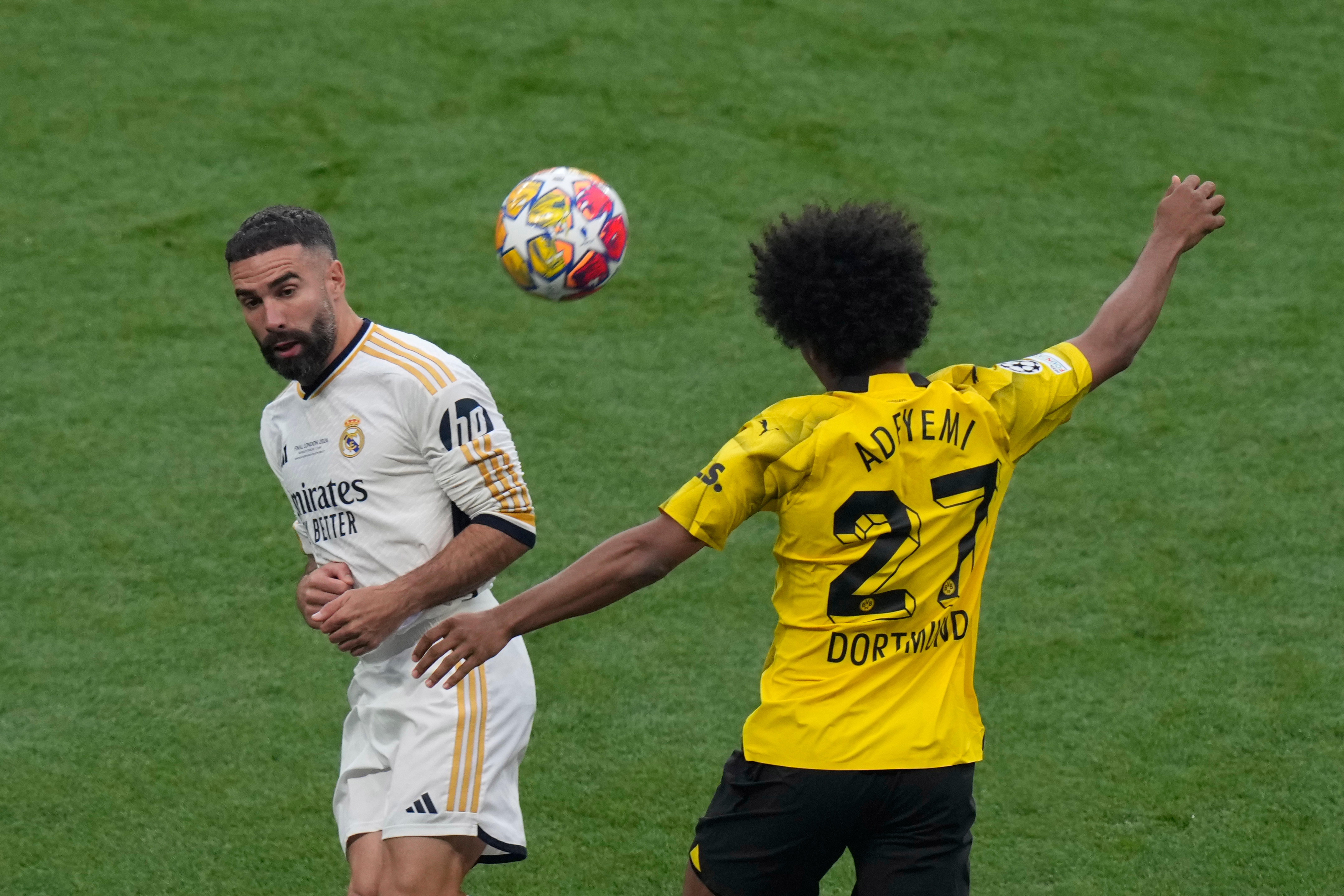 Dortmund’s Karim Adeyemi, right, heads the ball past Real Madrid’s Dani Carvajal