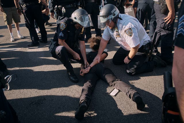 <p>Police detain a pro-Palestinian demonstrator in front of the Brooklyn Museum during a protest demanding a permanent cease-fire in Gaza on Friday, May 31, 2024</p>