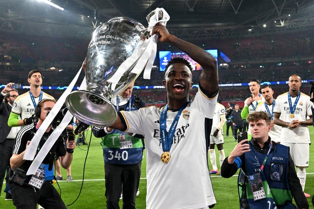 <p>Vinicius Jr celebrates with the Champions League trophy</p>