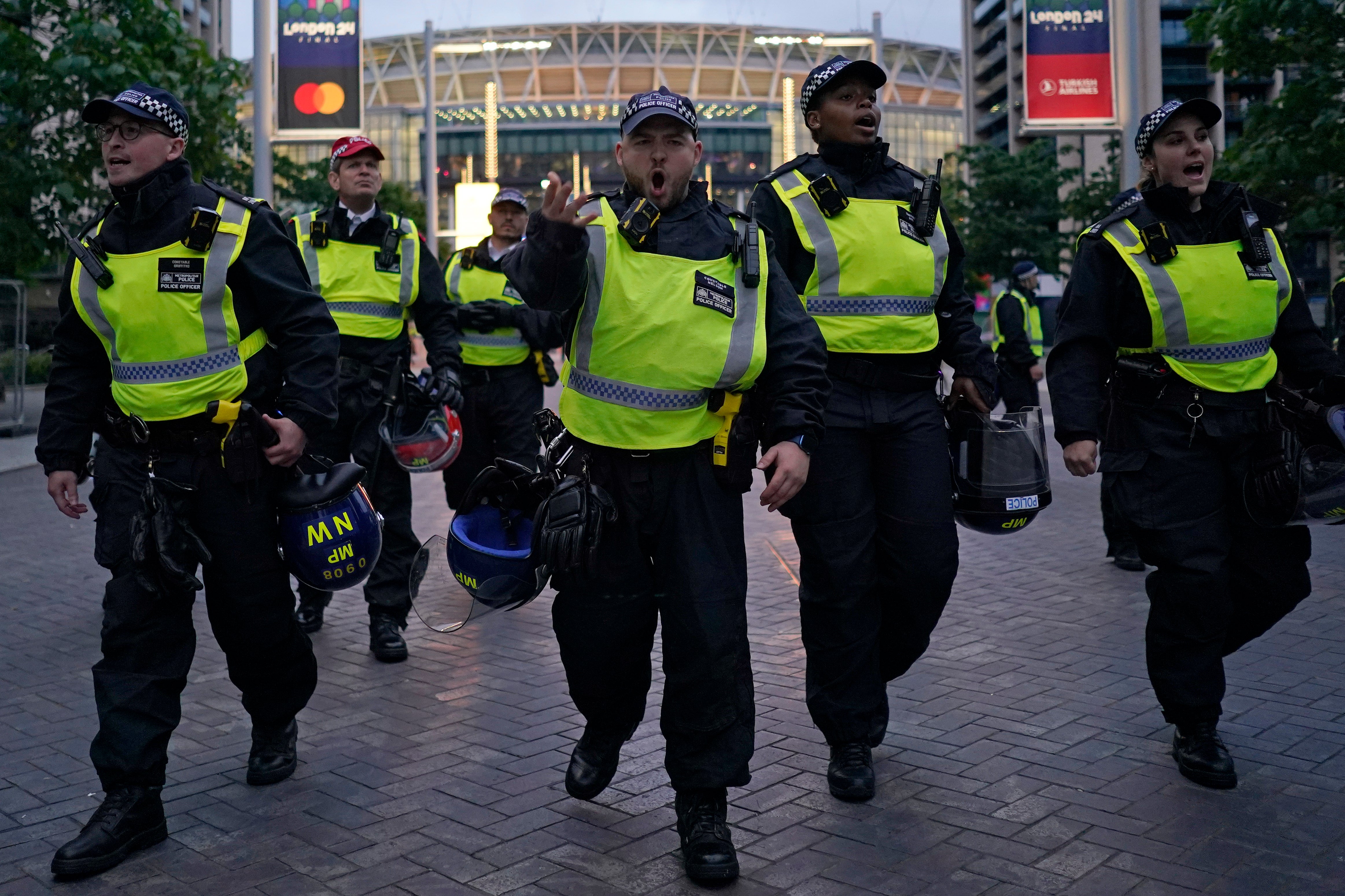 Police officers clear the road leading to Wembley Stadium during the Champons League final