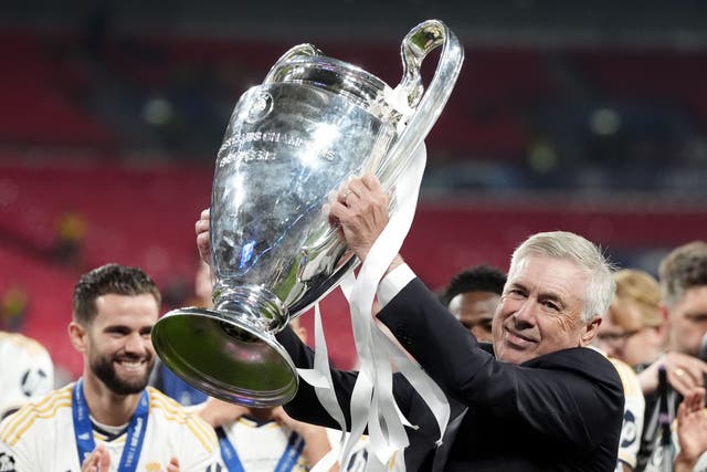 Real Madrid manager Carlo Ancelotti celebrates with the trophy after winning the UEFA Champions League final at Wembley (Nick Potts/PA)