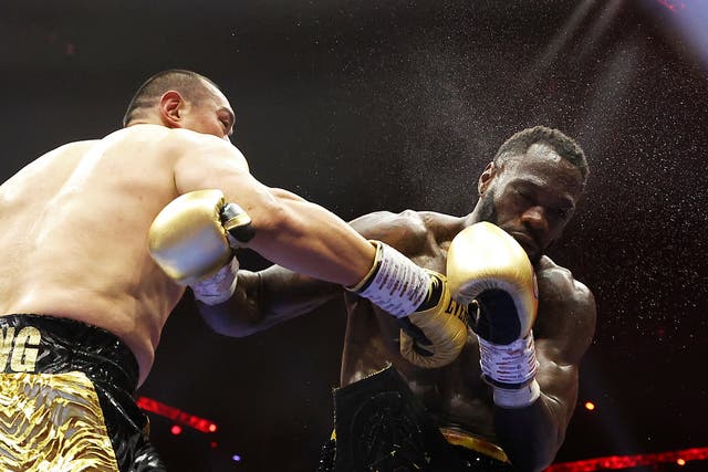 <p>Zhilei Zhang (left) finished Deontay Wilder with two right hooks</p>