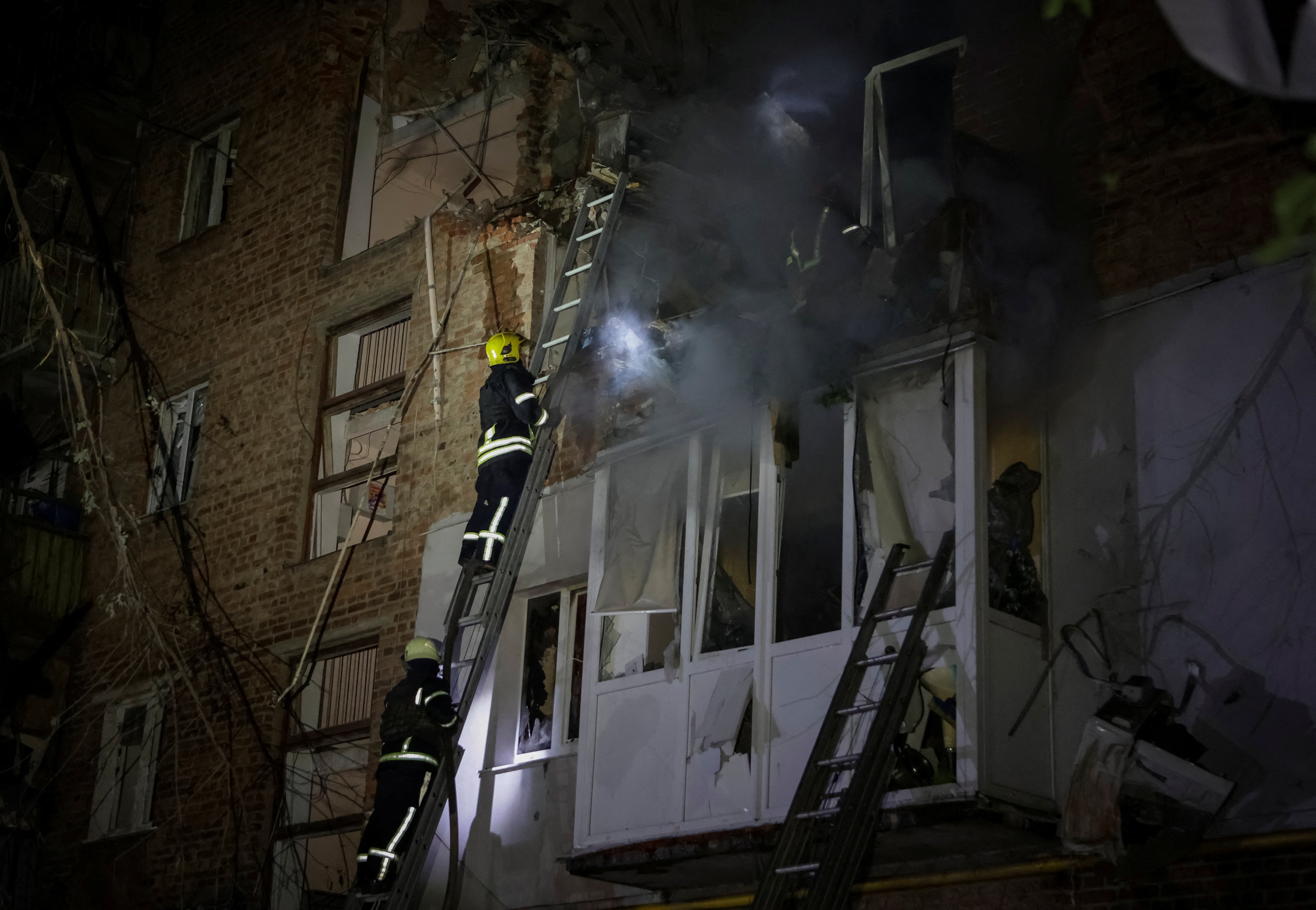 Firefighters work at a site of a residential building hit by a Russian missile strike, amid Russia’s attack on Ukraine, in Kharkiv, Ukraine 31 May 2024