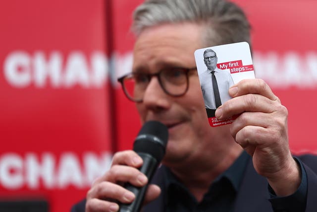 <p>Labour Party Leader Sir Keir Starmer holds a card detailing his policy priorities at the launch of the Labour Party election campaign ‘Battle Bus’ in Uxbridge</p>