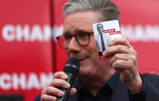 <p>Sir Keir Starmer holds a card detailing his policy priorities at the launch of the Labour Party election campaign battlebus in Uxbridge</p>
