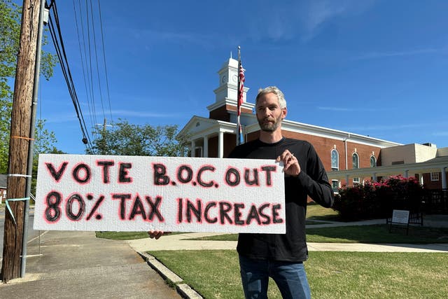 <p>Rob Romeijn protests property taxes outside Rockdale County offices in Conyers, Georgia, on April 23, 2024.</p>