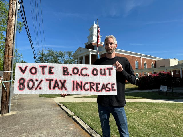 <p>Rob Romeijn protests property taxes outside Rockdale County offices in Conyers, Georgia, on April 23, 2024.</p>