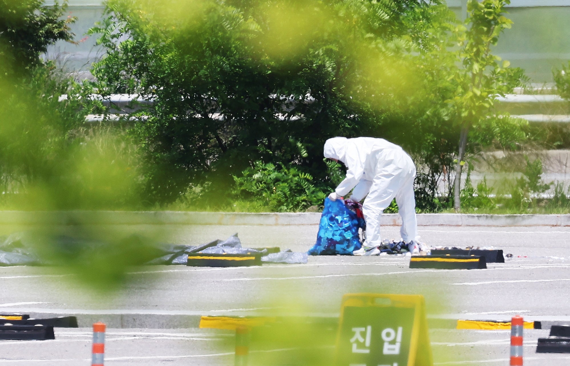 An official collects the debris of a balloon sent by North Korea at a shopping centre in Siheung, west of Seoul, on Sunday