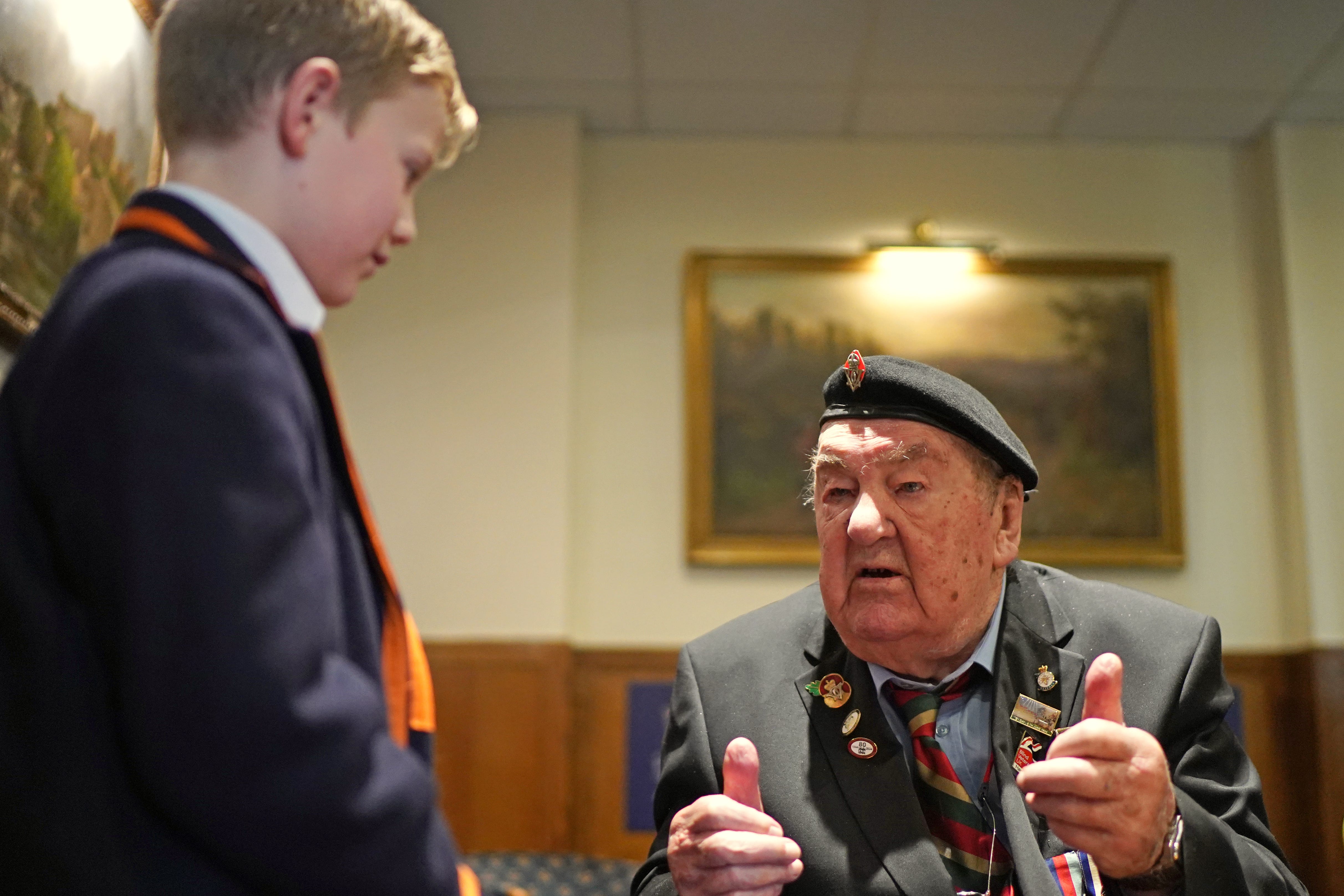 D-Day veterans Richard Aldred, 99, who served with the 7th Armoured Division of Royal Tank Regiment, meeting pupils from Norfolk House School (Gareth Fuller/PA)