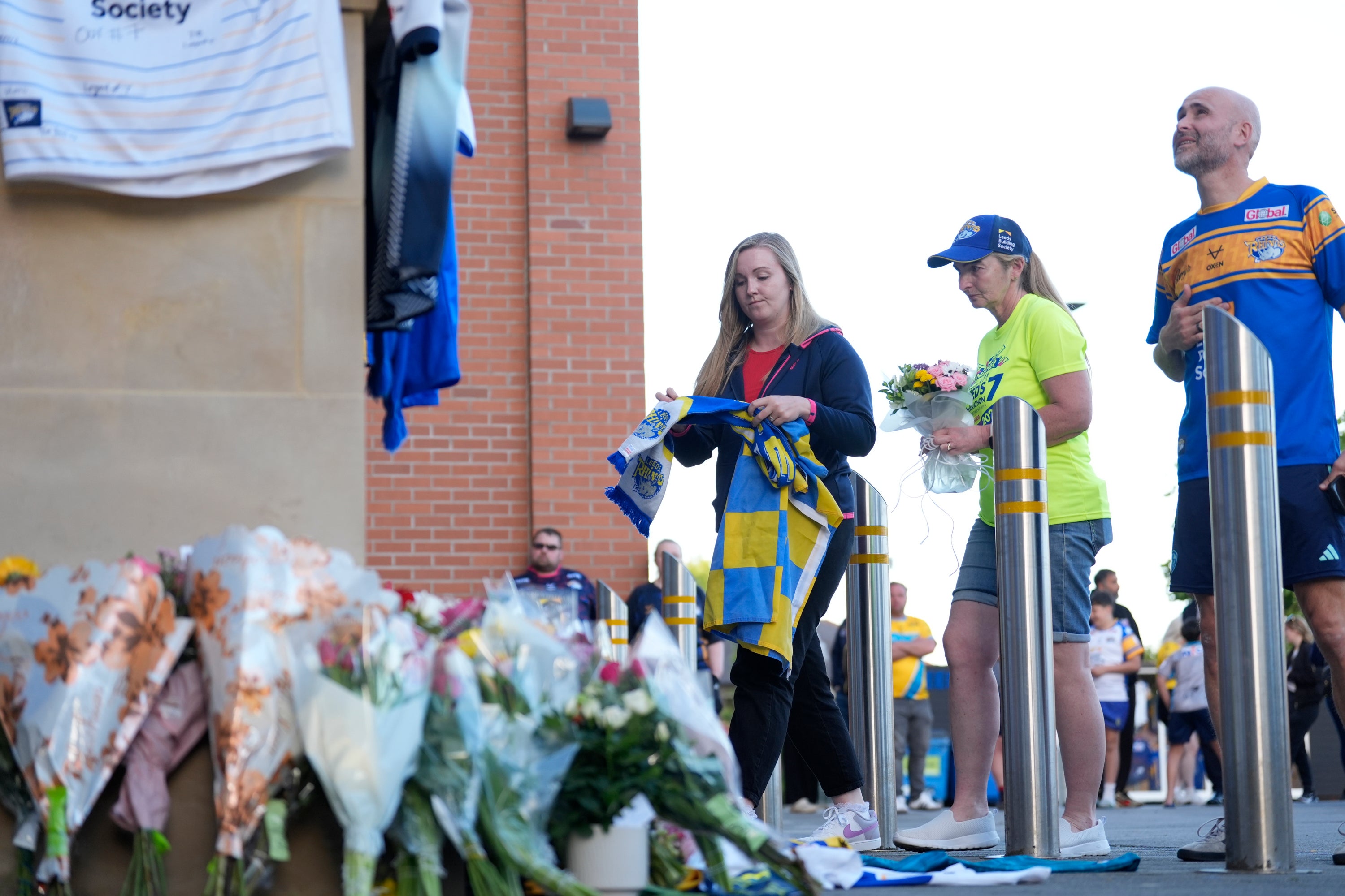 Fan carrying tributes arrive at Headingley Stadium in Leeds