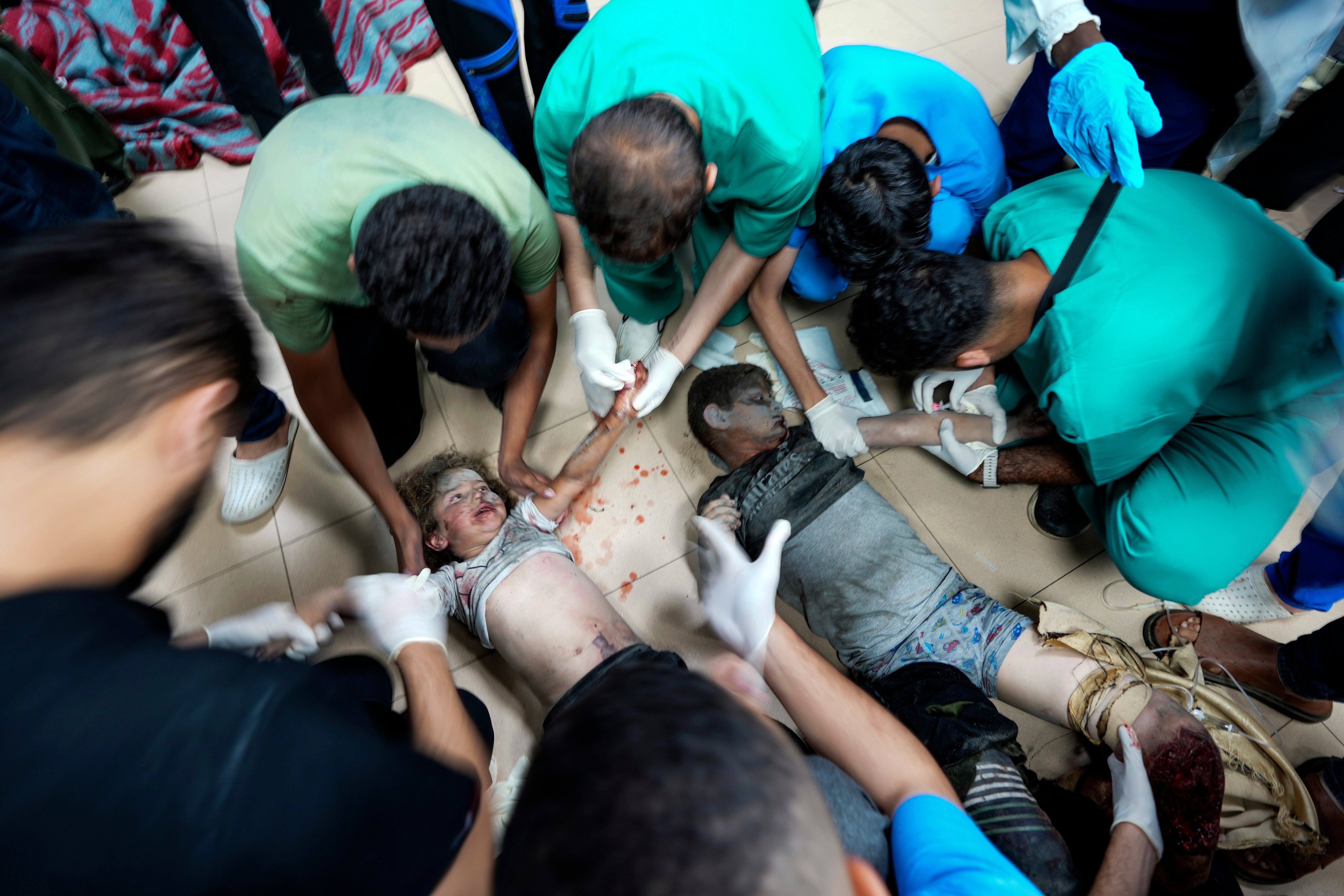 Palestinian medics at al-Aqsa Martyrs hospital in Deir al-Balah, central Gaza Strip, treat children wounded in an Israeli bombardment