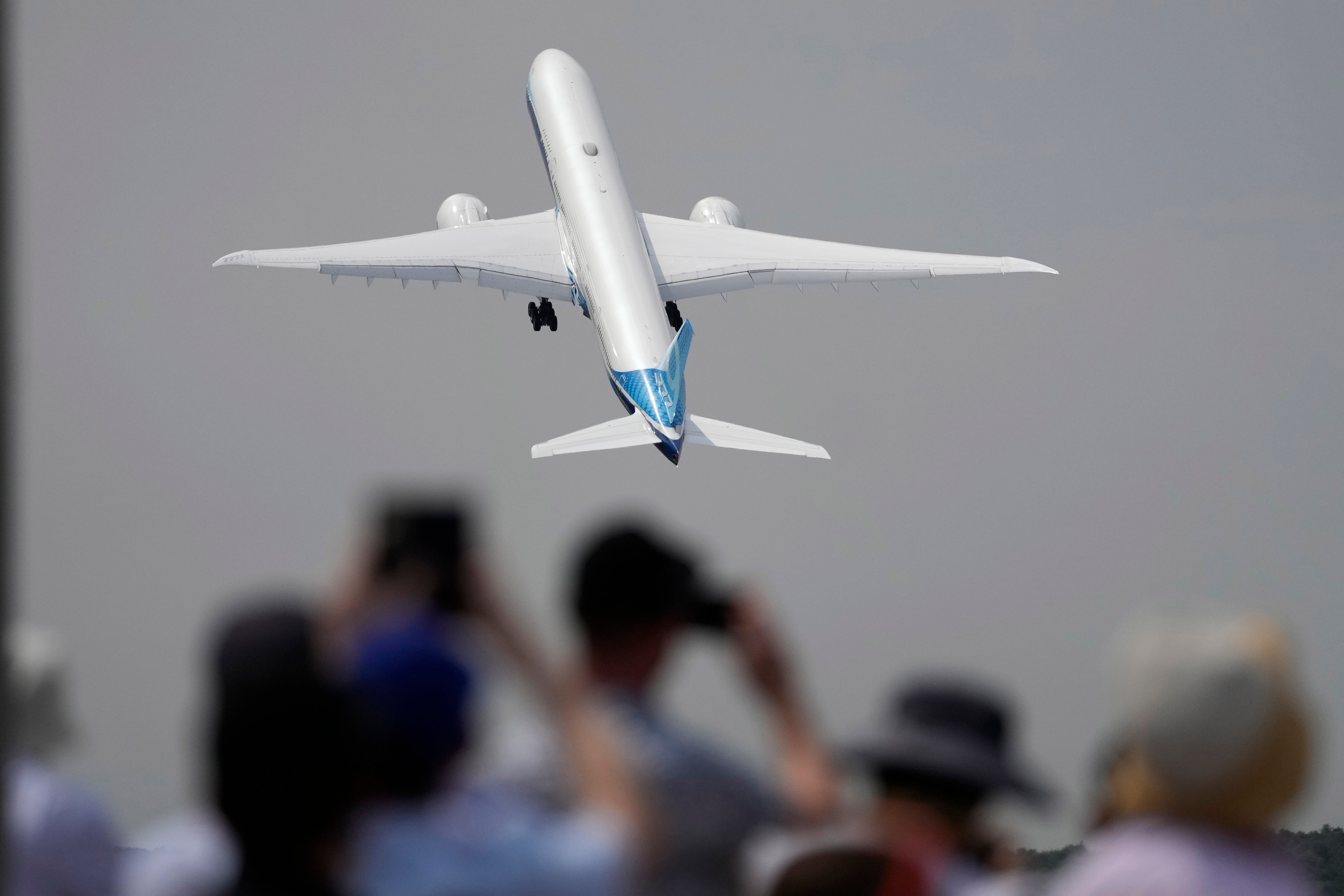 A Boeing 777X plane takes off at the Farnborough Air Show fair in Farnborough, England