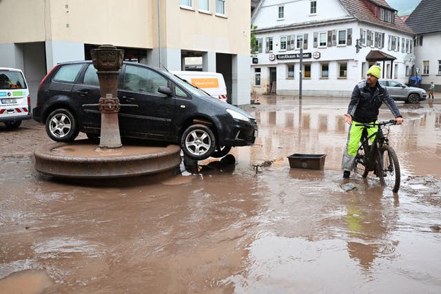 <p>A car washed away by floodwater rests on a well, in Rudersberg, Germany, Monday, June 3, 2024 </p>