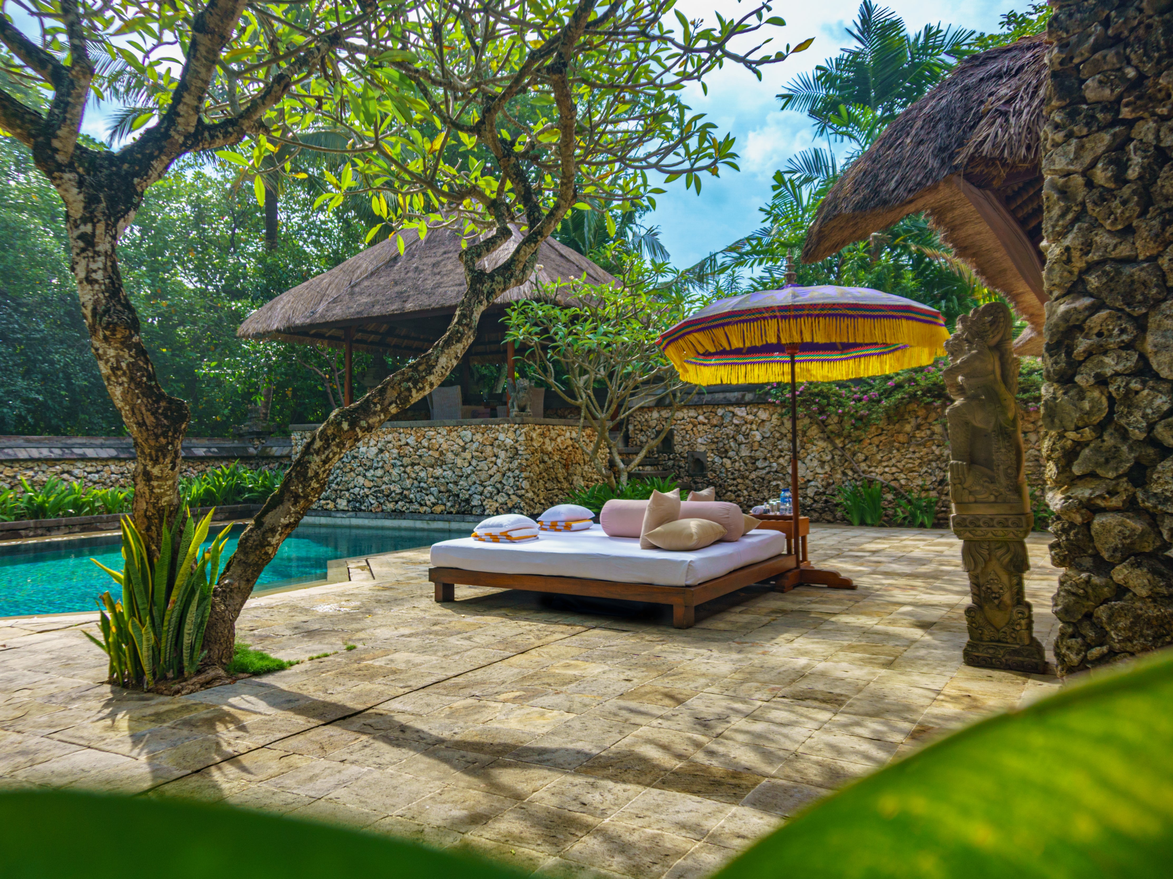 Time can disappear beside the pool at The Oberoi Beach Resort, Bali