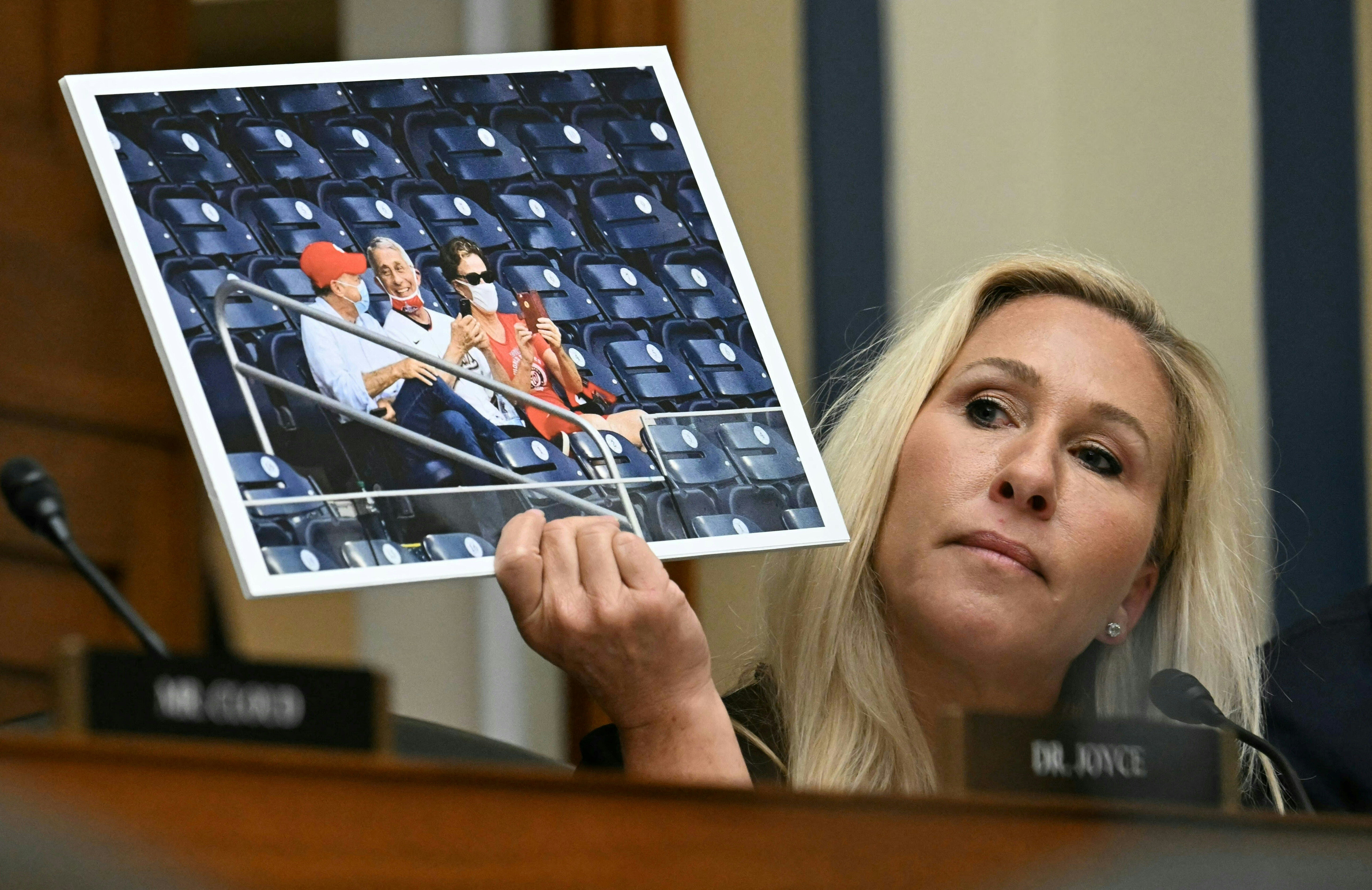 Rep Marjorie Taylor Greene holds up an image of Dr Fauci during contentious moment during hearing