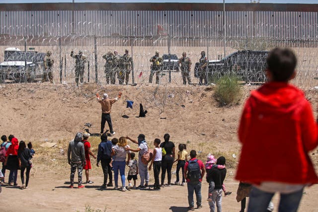 <p>Migrants on the Mexican side of the US-Mexico border engage in a confrontation with Texas National Guard troops on May 13, 2024 </p>