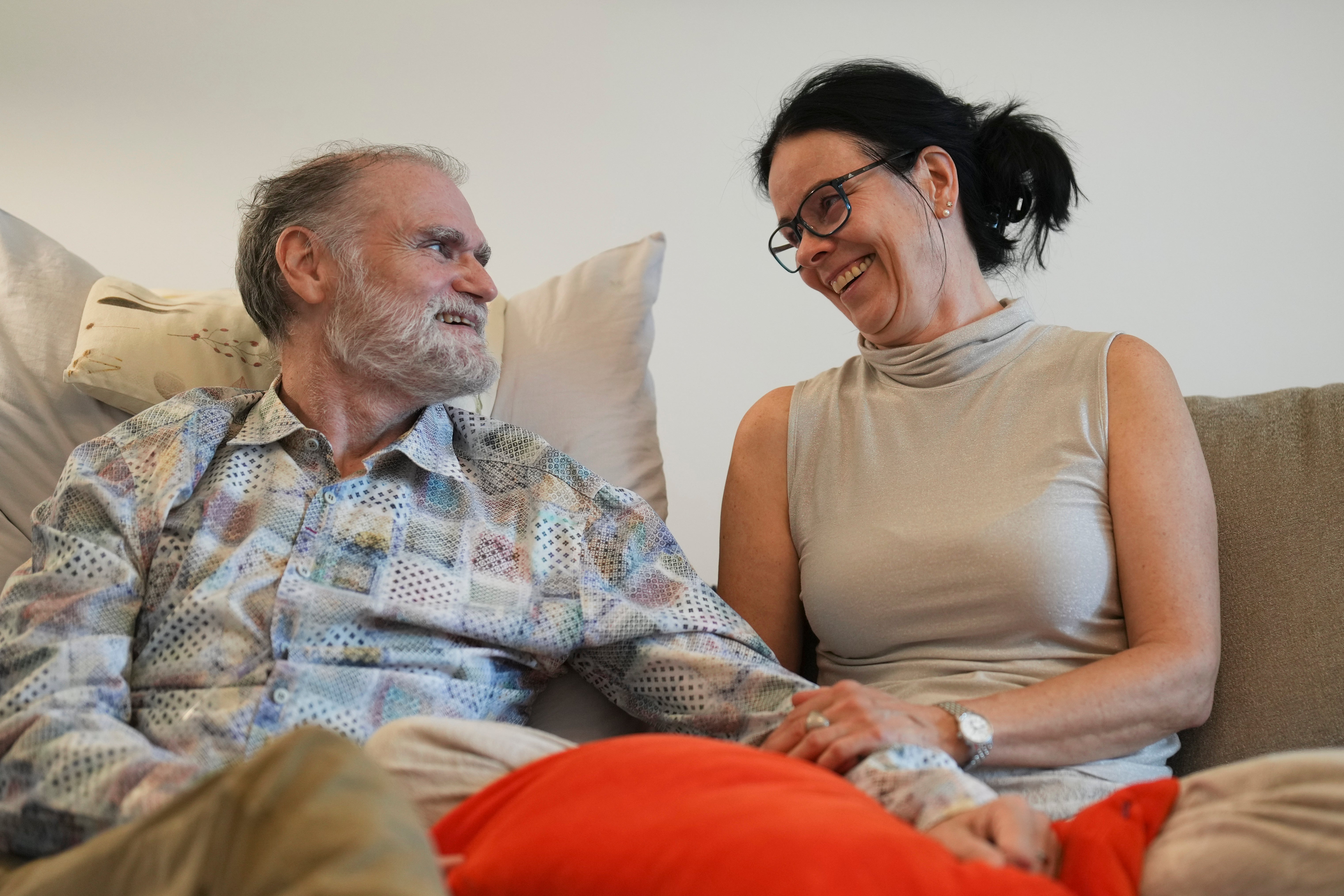 Michael Bommer, left, who is terminally ill with colon cancer, looks at his wife Anett Bommer