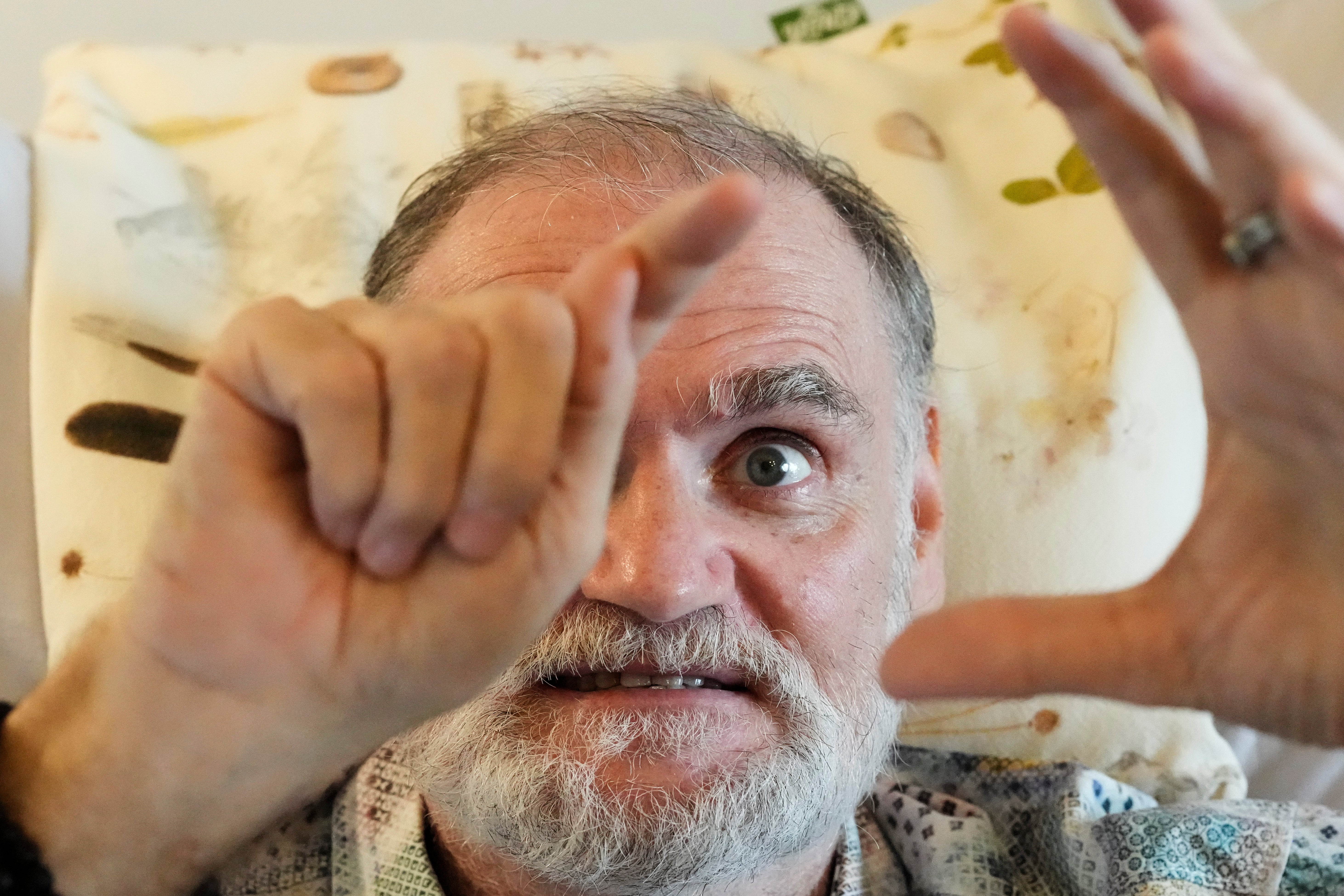 Michael Bommer, who is terminally ill with colon cancer, gestures during a meeting with The Associated Press at his home in Berlin, Germany, Wednesday, May 22, 2024. Bommer, who has only a few more weeks to live