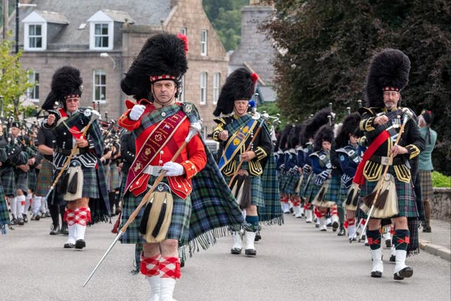 <p>Tartan army: Pipe band marching at Ballater Highland Games</p>