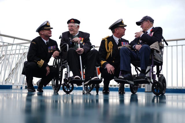 (l to r) Royal Navy Commander Glen Hickson, D-Day veteran Jim Grant, Royal Navy Commodore John Voyce, and D-Day veteran Charles Horne on board the Brittany Ferries ship Mont St Michel (Jordan Pettitt/PA)