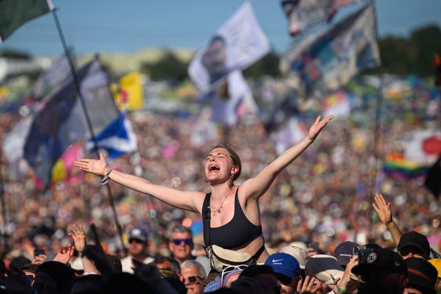 <p>A reveller sings along as Lewis Capaldi performs on the Pyramid Stage at Glastonbury 2023</p>