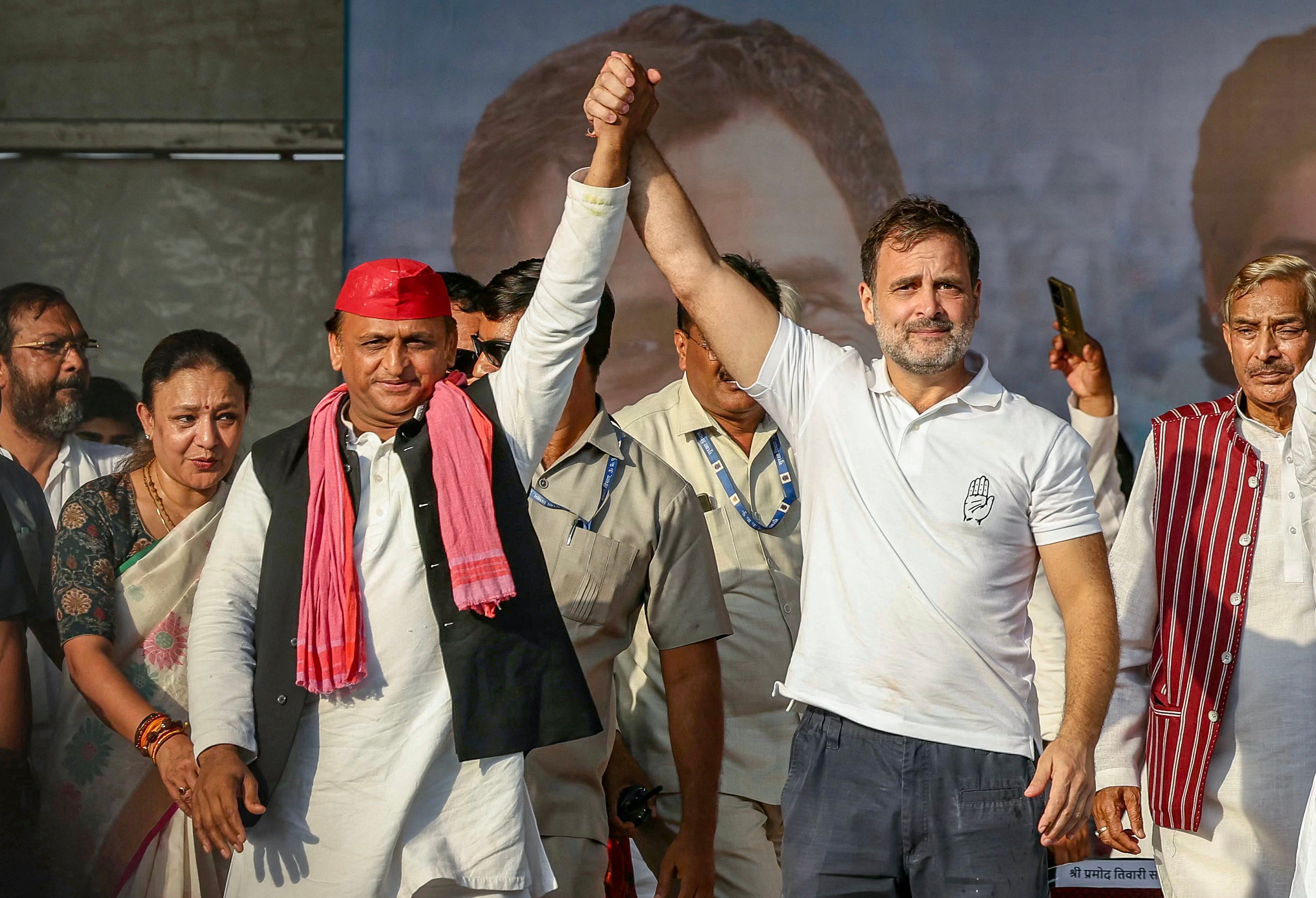 Indian National Congress (INC) Party leader Rahul Gandhi (2R) and Samajwadi Party President Akhilesh Yadav (C) gesture as they arrive to attend an election rally of Indian National Developmental Inclusive Alliance (INDIA) on the outskirts of Varanasi on 28 May 2024, during country’s ongoing general election.