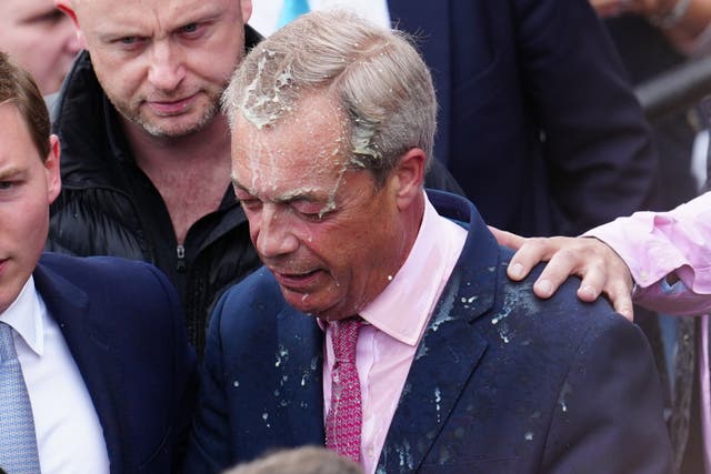 <p>Reform UK party leader Nigel Farage reacts after a woman threw a milkshake over him</p>