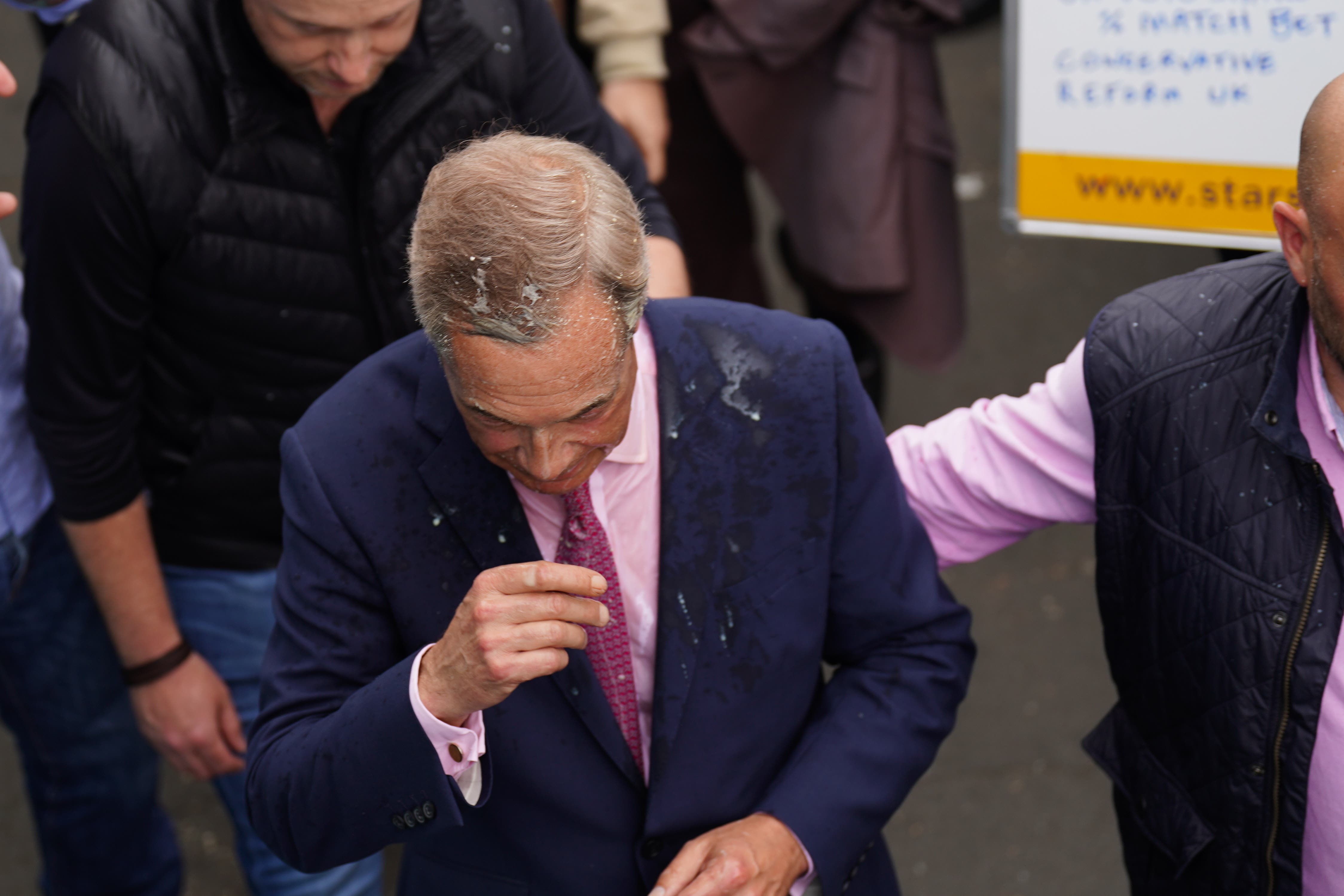 Farage after a drink was thrown over him as he leaves the Moon and Starfish pub in Clacton (James Manning/PA)