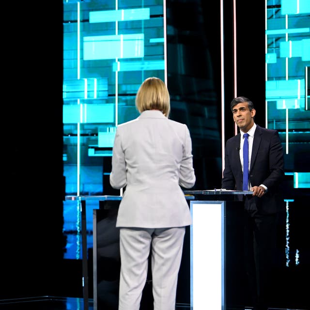 <p>Host Julie Etchingham in the centre of the ITV Debate studio with Sir Keir Starmer and Rishi Sunak stood behind podiums</p>
