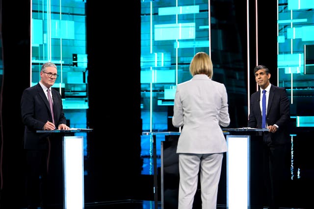 <p>Host Julie Etchingham in the centre of the ITV Debate studio with Sir Keir Starmer and Rishi Sunak stood behind podiums</p>