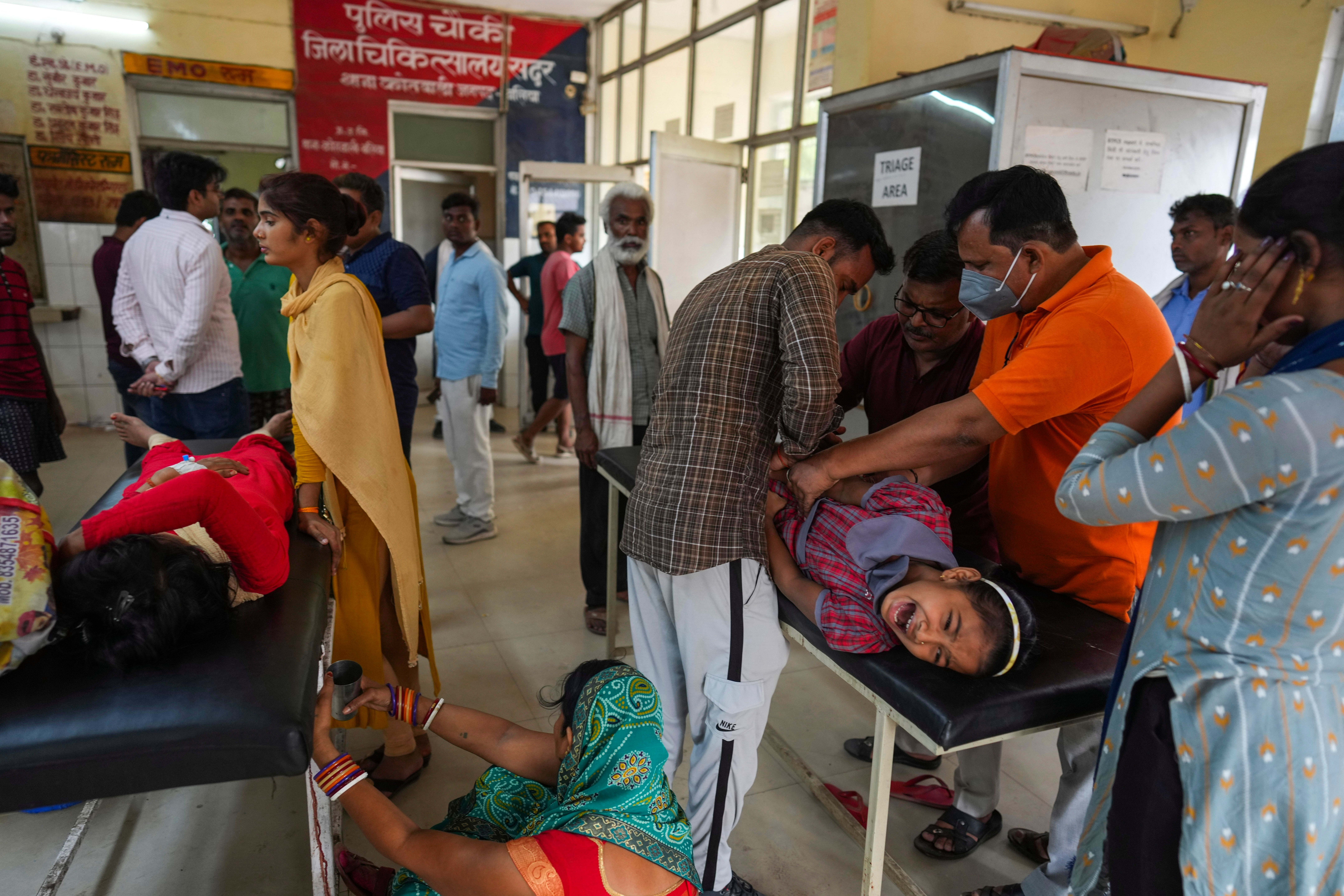 People suffering from heatstroke are treated in a hospital in Ballia in the northern Uttar Pradesh state