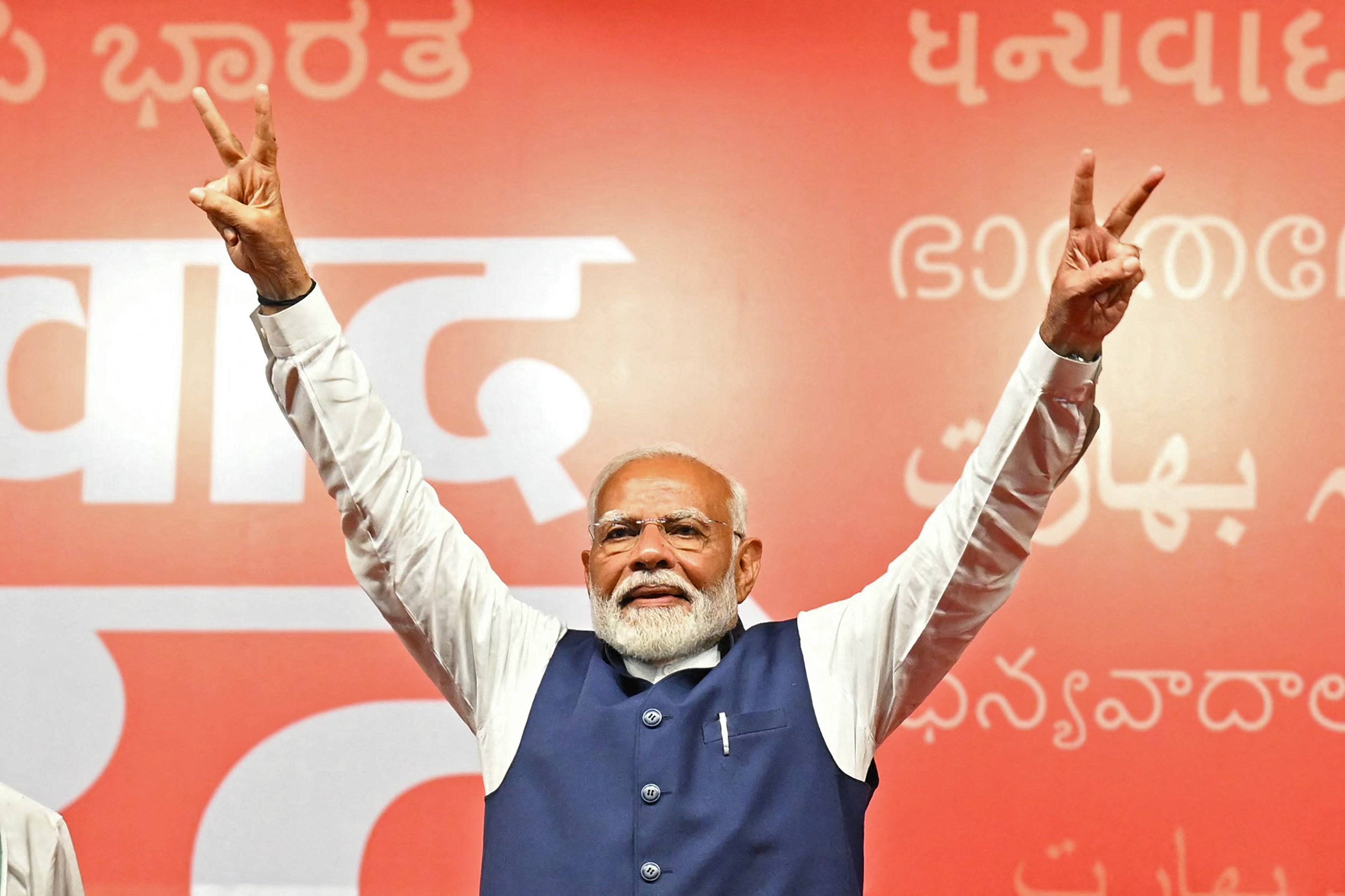 India’s prime minister Narendra Modi flashes victory sign at the Bharatiya Janata Party (BJP) headquarters to celebrate the party’s win in country’s general election, in New Delhi on 4 June 2024