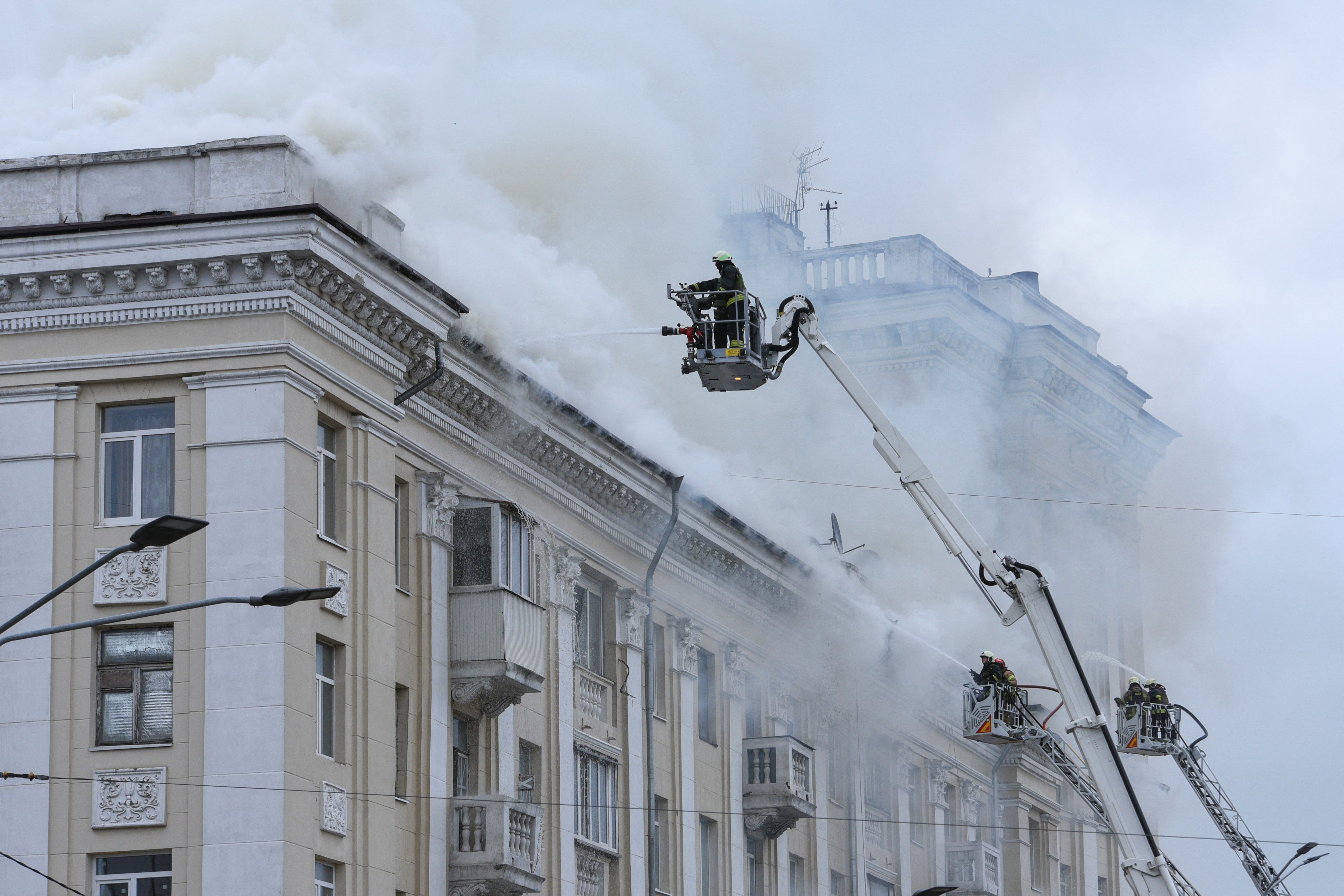 Firefighters work at a site of an apartment building hit by a Russian missile strike, amid Russia's attack on Ukraine, in Dnipro