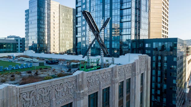 <p>An ‘X’ sign rests atop the company headquarters in downtown San Francisco, on July 28, 2023</p>