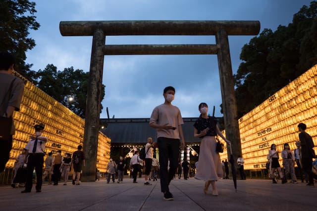 <p>File: People walk past lit paper lanterns during the Mitama Matsuri summer festival at the Yasukuni Shrine </p>