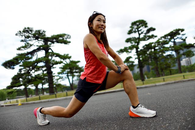 <p>Tomomi Bitoh, 33, Japan’s top ultra runner, stretches as she takes part in a workout session around the Imperial Palace in Tokyo, Japan June 4, 2024</p>