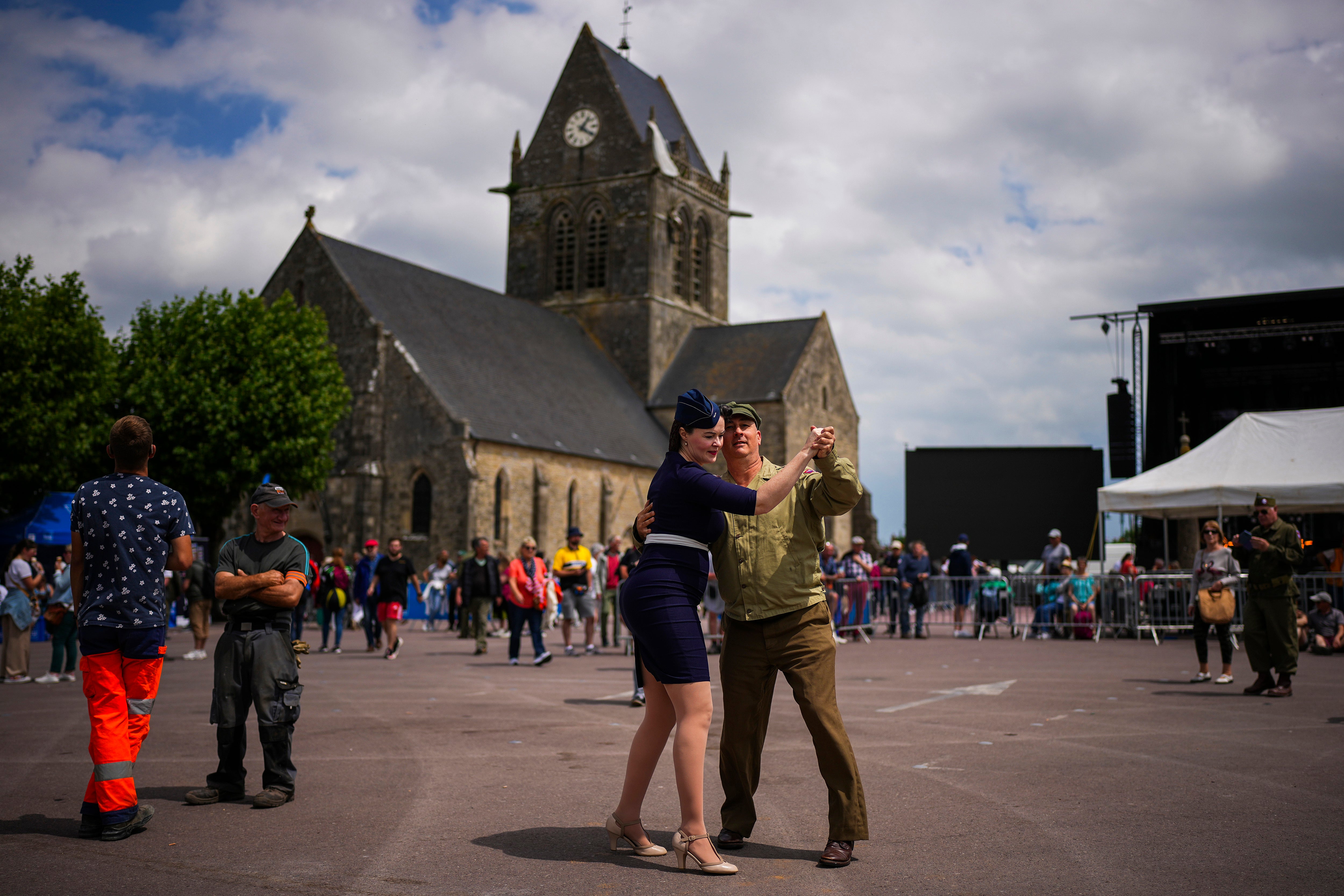 Re-enactors dance at Sainte-Mere-Eglise town square, Normandy, France,