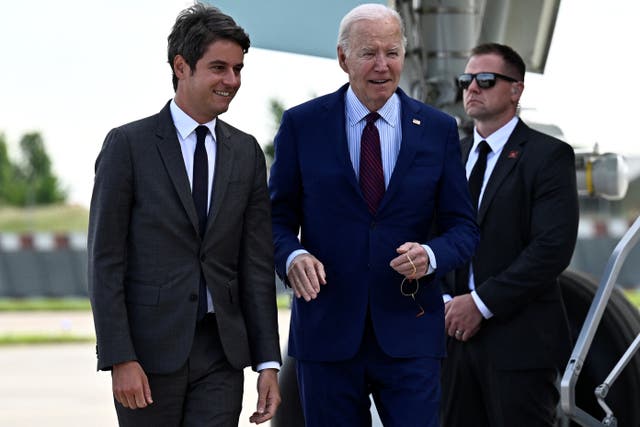 <p>US President Joe Biden (C) is welcomed by France's Prime Minister Gabriel Attal upon arrival at Paris Orly airport near Paris, on June 5, 2024, as he travels to commemorate the 80th anniversary of D-Day</p>