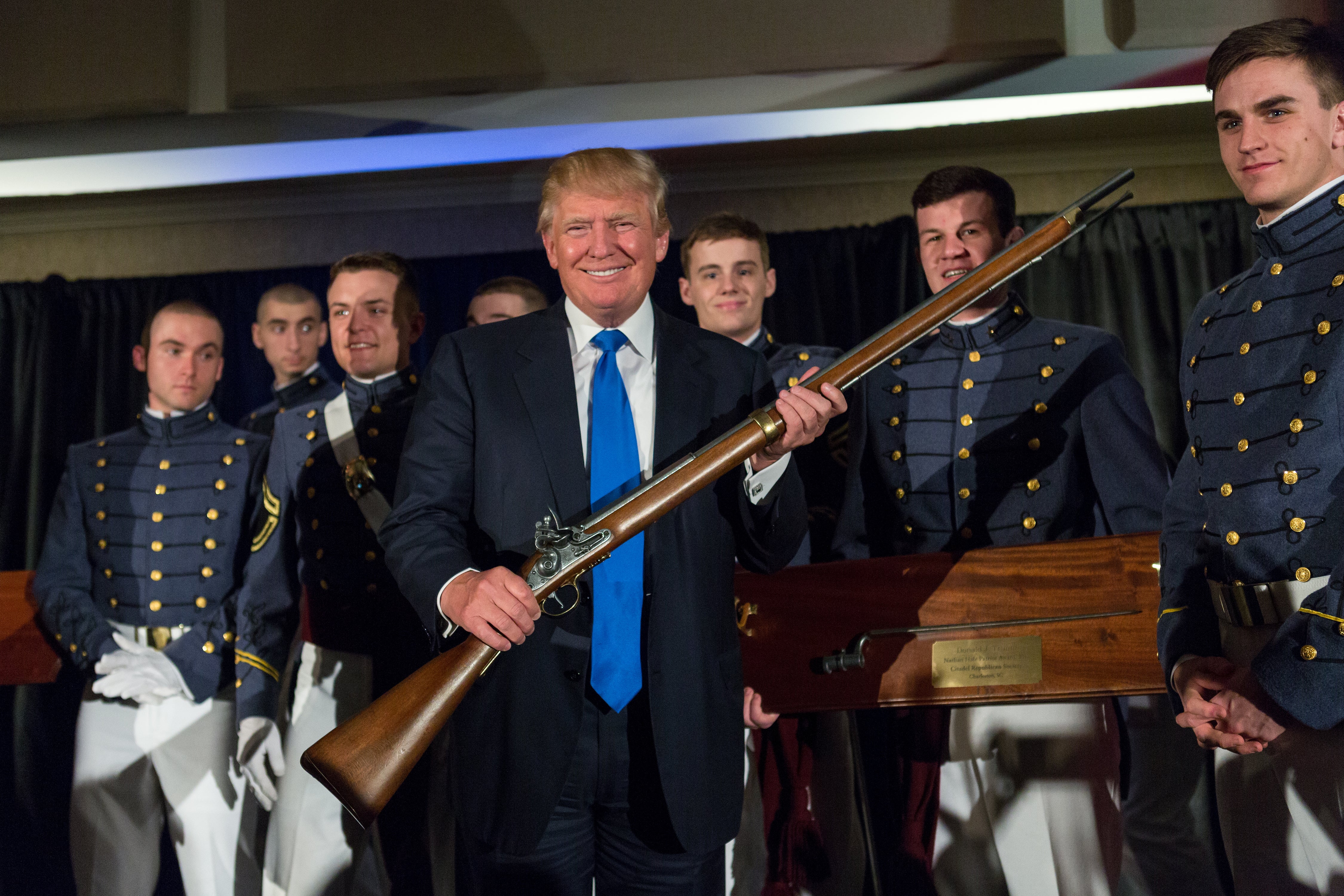 Donald Trump holds up a replica flintlock rifle awarded him by cadets during the Republican Society Patriot Dinner at the Citadel Military College on February 22, 2015 in Charleston, South Carolina. NYPD officials are set to revoke his gun licenese following his felony conviction.