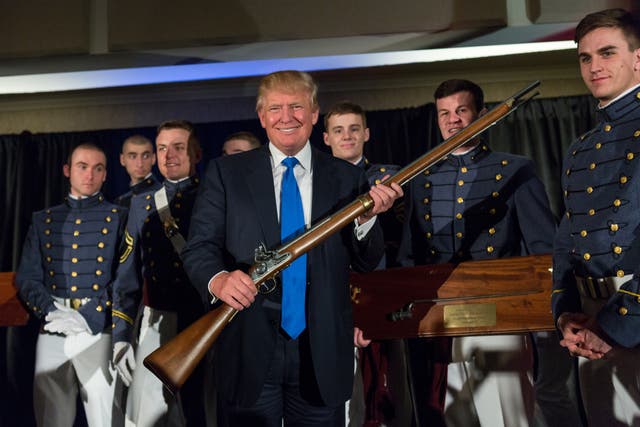 <p>Donald Trump holds up a replica flintlock rifle awarded him by cadets during the Republican Society Patriot Dinner at the Citadel Military College on February 22, 2015, in Charleston, South Carolina. NYPD officials are set to revoke his gun licenese following his felony conviction.   </p>
